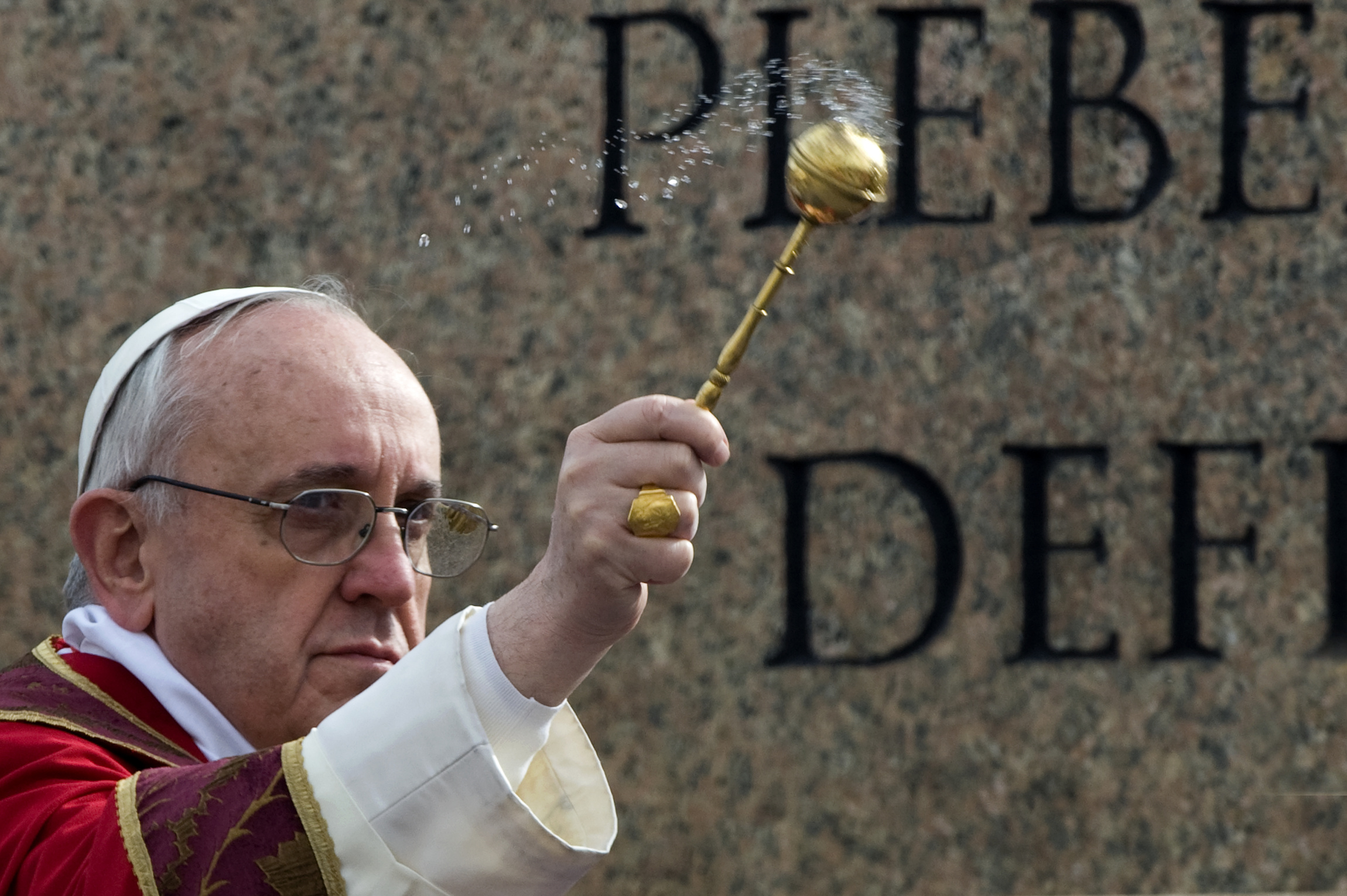 Pope Francis blesses palms as he begins Palm Sunday Mass at Vatican